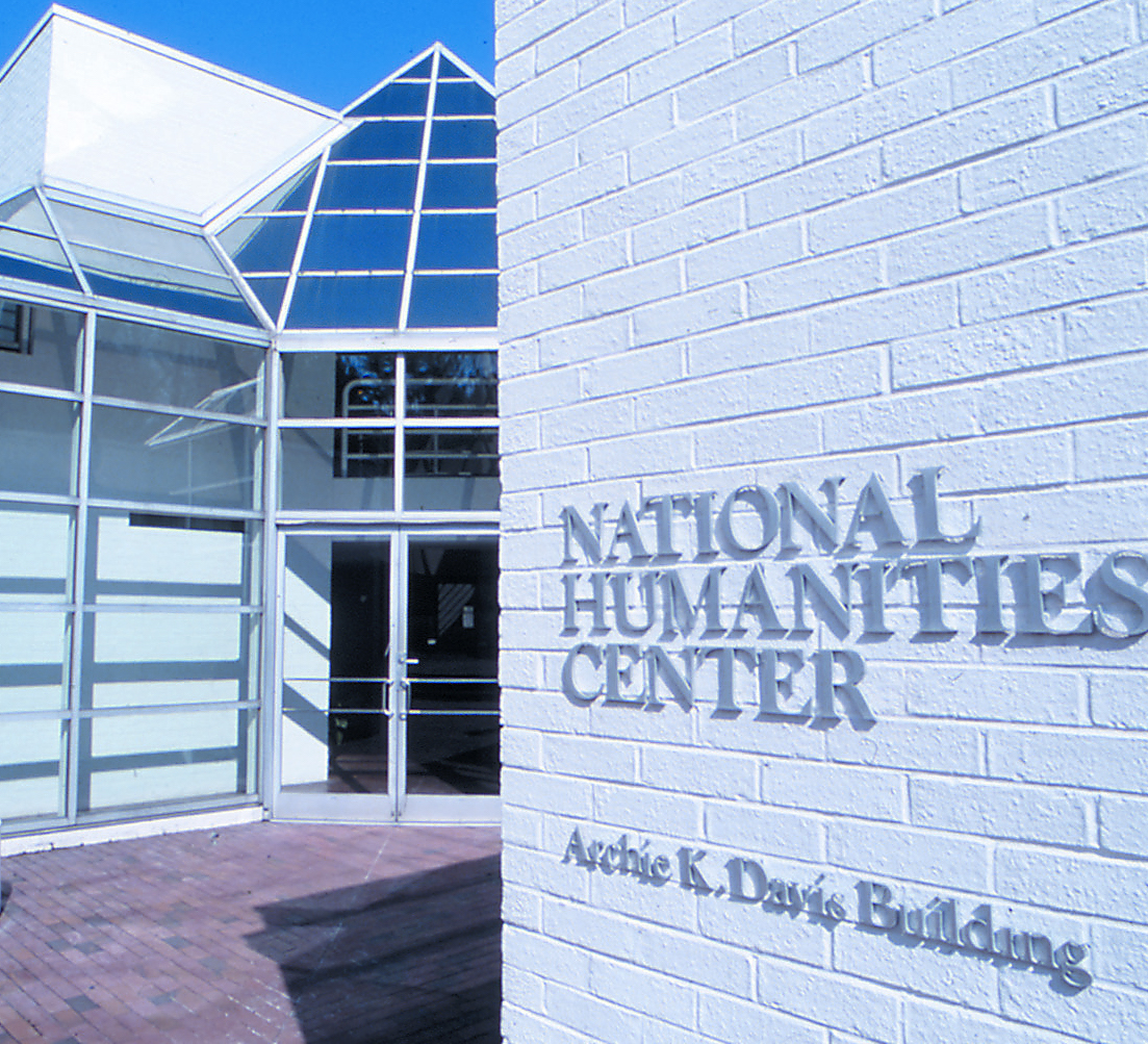 Exterior of the National Humanities Center, Archie K. Davis Building, with its name prominently displayed on a white brick wall.